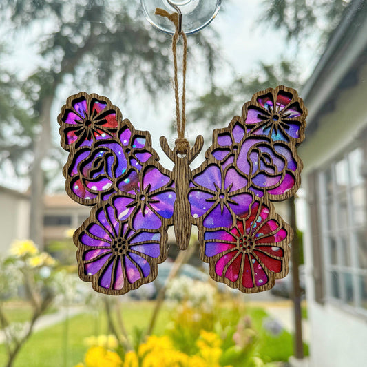Floral butterfly suncatcher made from wood and acrylic hanging in window shown in the dark stain option.