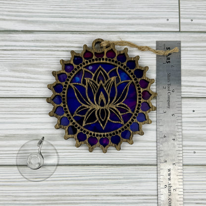 Lotus flower suncatcher made from wood and acrylic lying flat with a ruler showing the approximate height.
