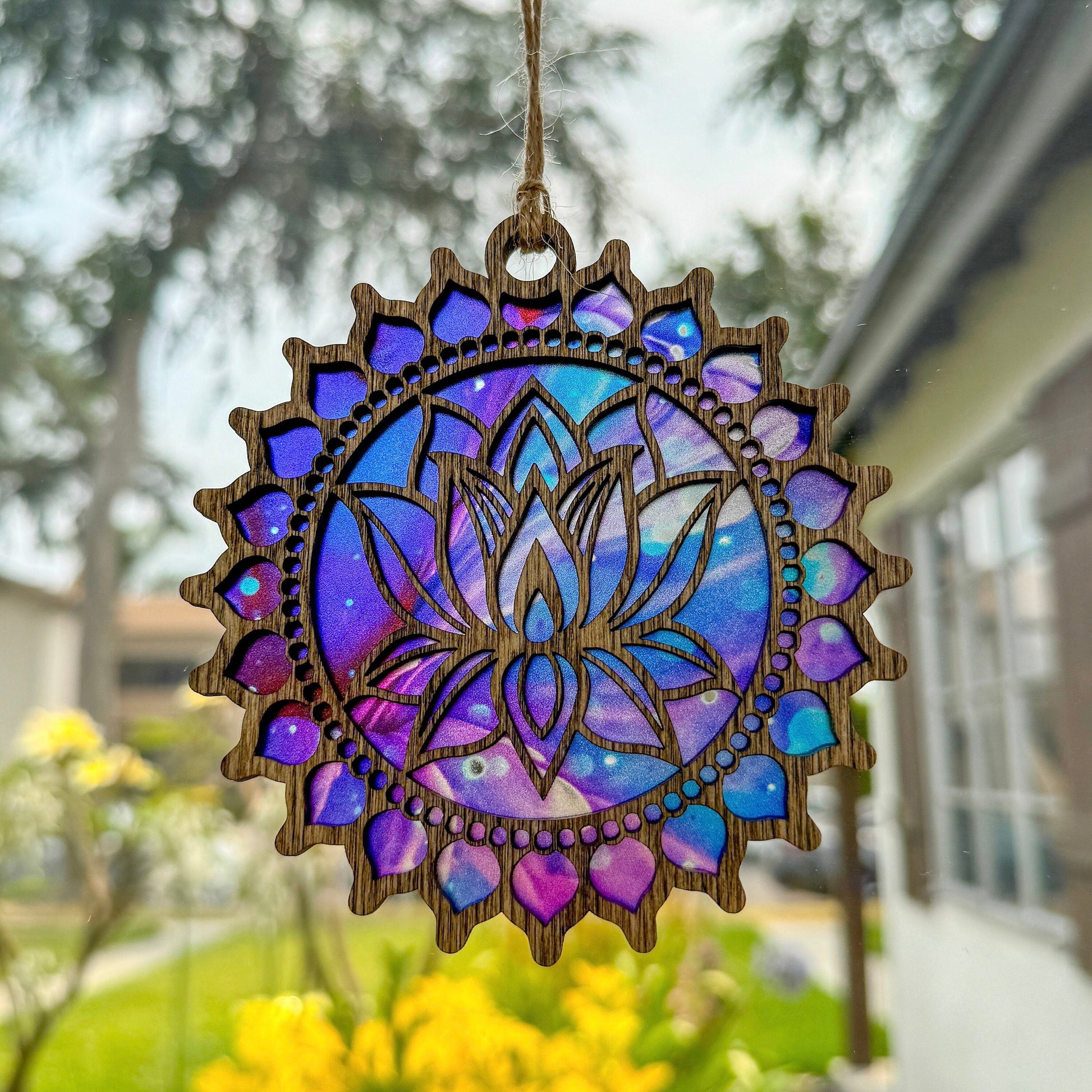 Lotus flower suncatcher made from wood and acrylic hanging in window