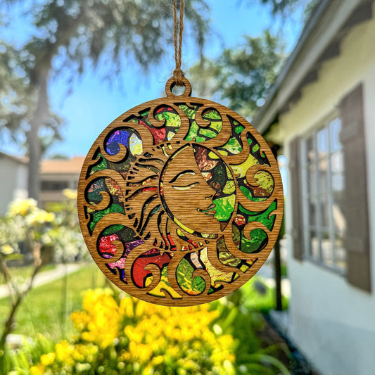 Whimsical sun suncatcher made from wood and acrylic hanging in window